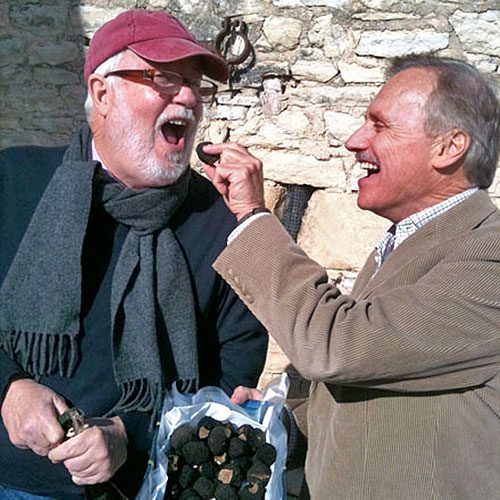 Two men sharing bag of roasted nuts in winter Burgundy France