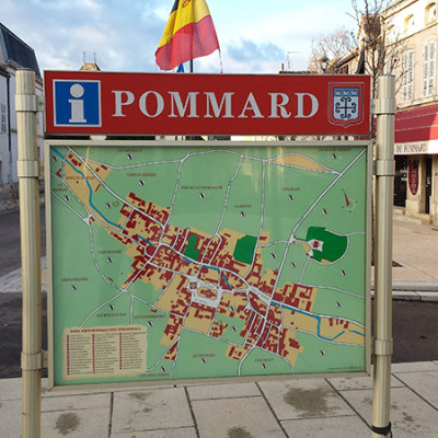 Outdoor village street sign with map of Pommard France